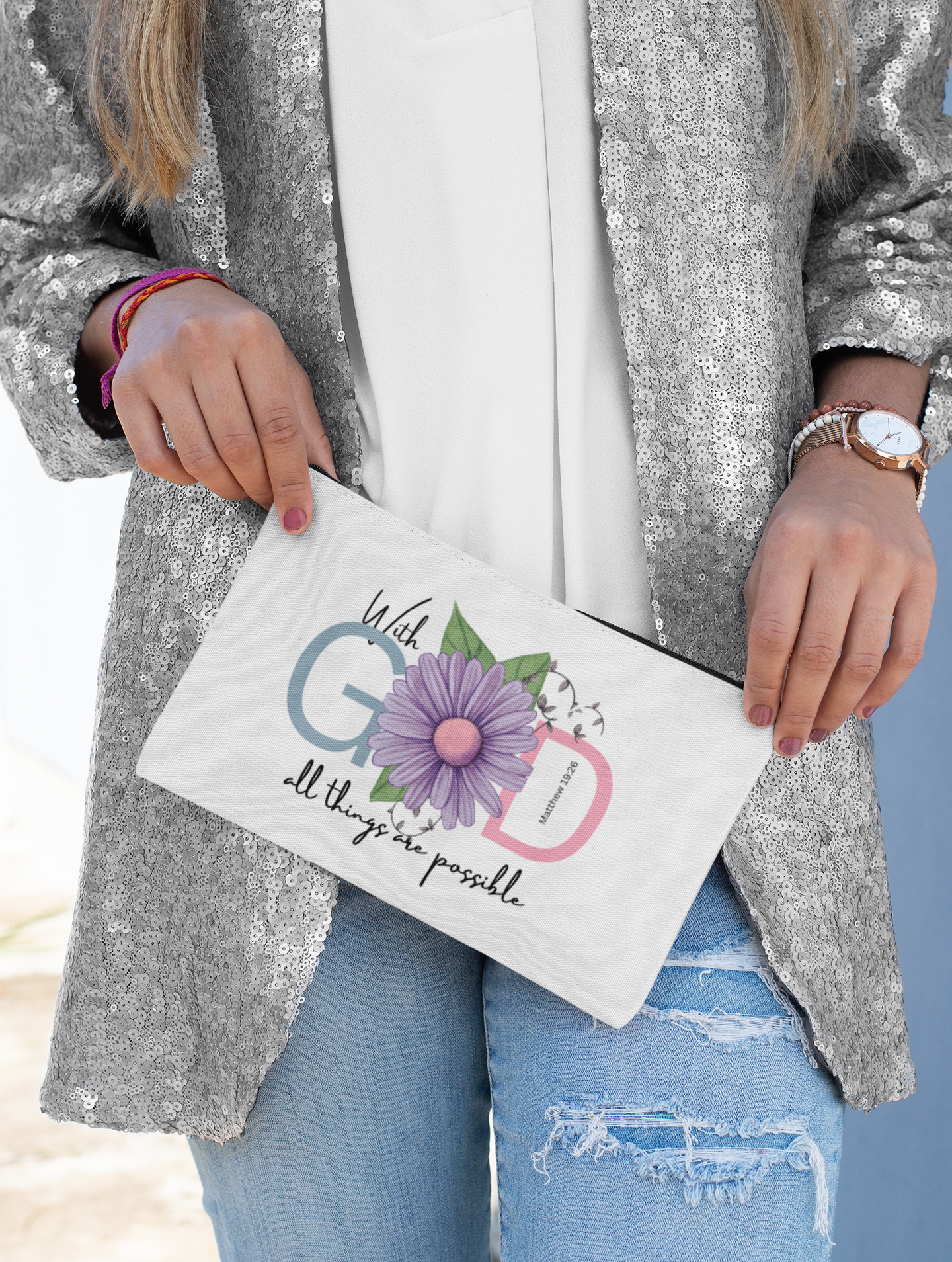 Person holding a clutch with floral design and text